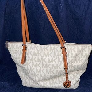 Micheal kors purse light cream colored almost white with light brown straps.